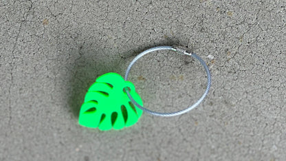 Cute personalized small monstera leaf in bright green with a 2mm silver coated cable wire keychain.
