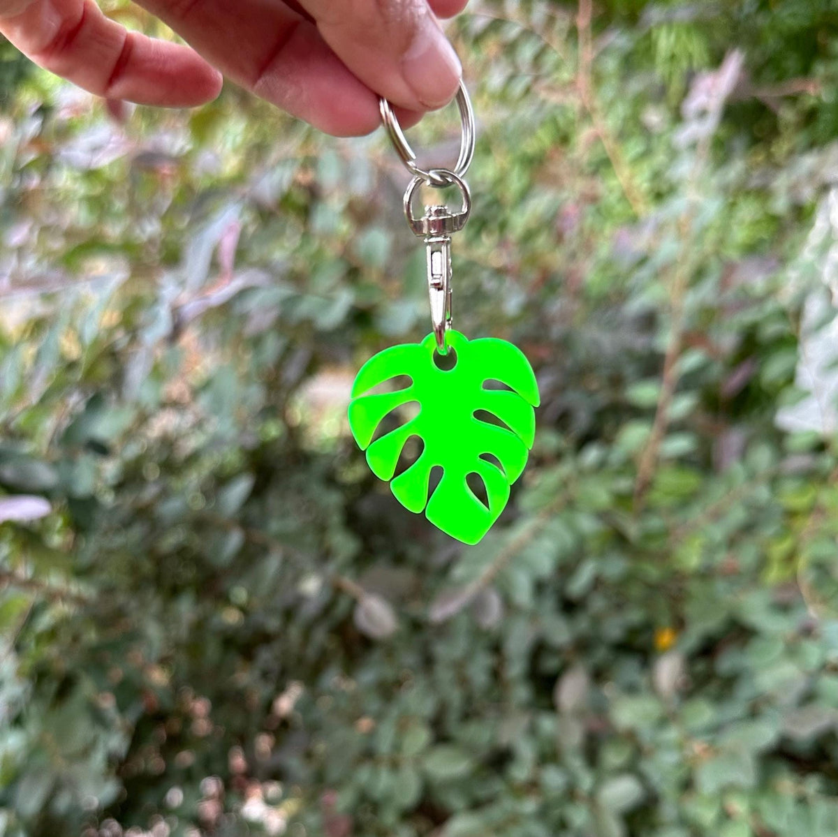 Cute personalized small monstera leaf in bright green with a stainless steel lobster claw keychain.