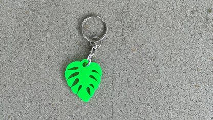 Cute personalized small monstera leaf in bright green with a lobster claw keychain shiny side.